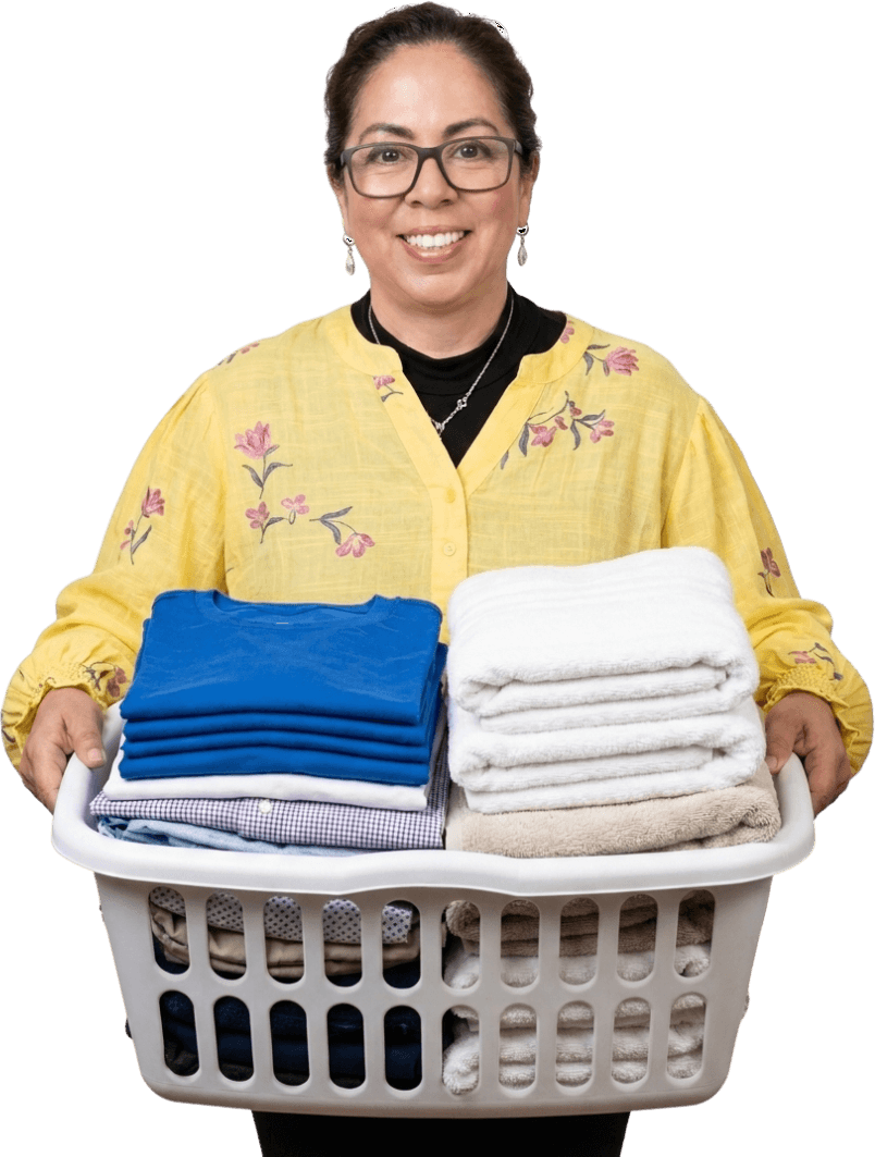 Marilu, owner of Relax Wash, holding a basket of folded laundry